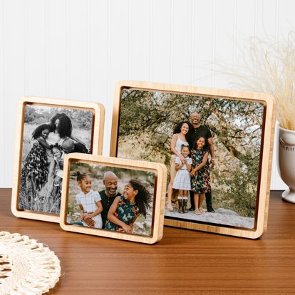 A collection of three bamboo float framed metal prints on a desk.