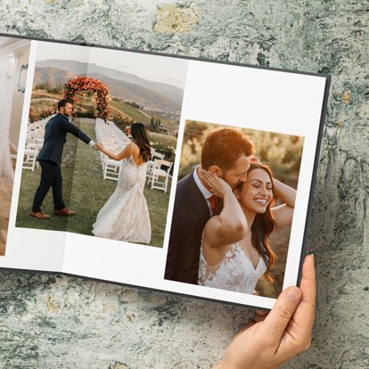 Leather wedding album spread open on a table.