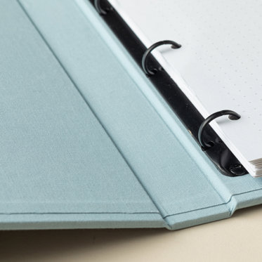 A close up image of an open Slip-In Photo Album from Mpix showing quality of the cover, spine, and three-ring binder.