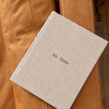 Mpix Premium Hardcover Photo Book with a Sand Linen cover and foil stamped debossed text that reads "Mr. Slater"