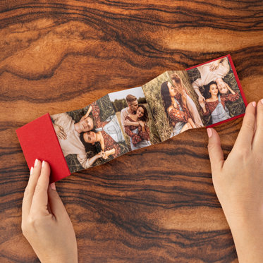 Holiday themed accordion mini brag book with 'joyful' on the front cover.