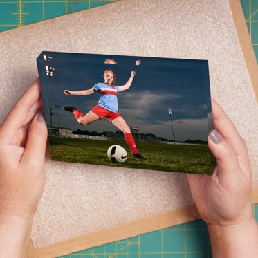 Acrylic Photo Block from Mpix featuring a personalized sports photo of a soccer player taking a shot 