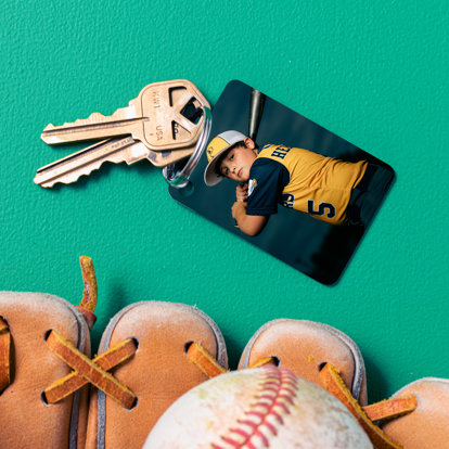 metal keychain with a baseball player posing with his bat in the air ready to hit a home run