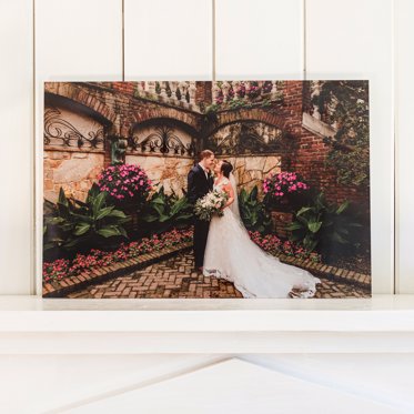 Acrylic photo print from Mpix featuring a couple on their wedding day celebrating in a rose garden
