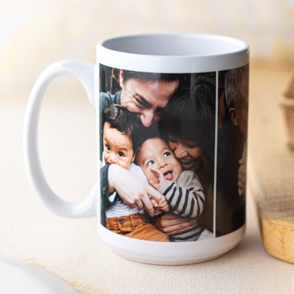 A photo mug sitting on a countertop and featuring an image of parents snuggling their young children.