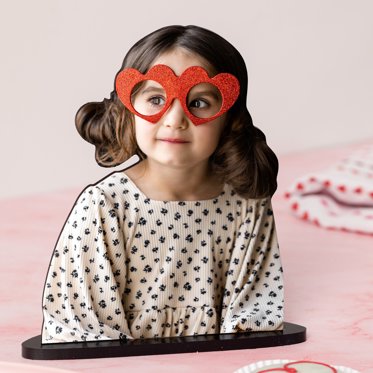 Mpix personalized statuette showing the die-cut image of a girl wearing heart-shaped glasses displayed on the acrylic stand.