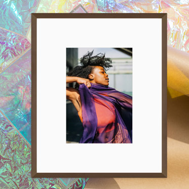 A framed print from Mpix with a thin metal frame featuring a graduation photo.