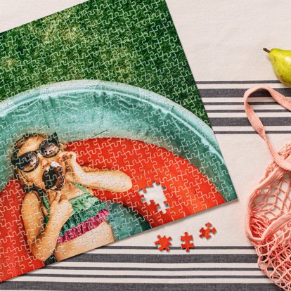 A custom jigsaw photo puzzle from Mpix featuring a picture of a young girl in a kiddie pool eating an ice cream bar.