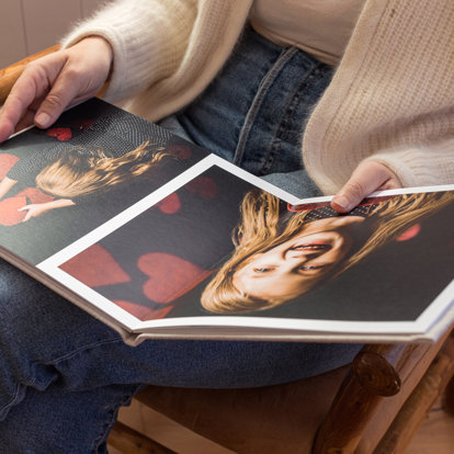 Mpix Premium Hardcover Photo Book with Valentine's Day themed family photos being read.