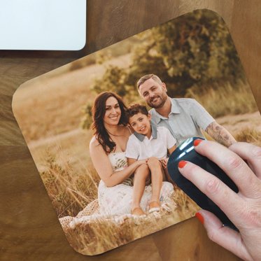 A customized mouse pad from Mpix with a family photo printed on the smooth polyester surface.