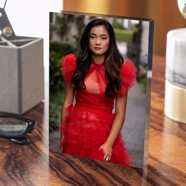 An acrylic photo block from Mpix featuring on a wooden table featuring a girl in a flowing red dress