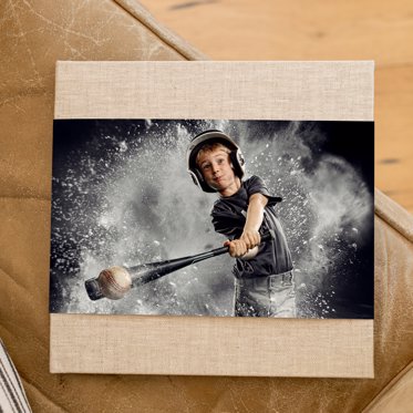 Premium hardcover photo book from Mpix with a skinny dust jacket and sand linen cover featuring a cover photo of a tee ball player hitting a ball. 