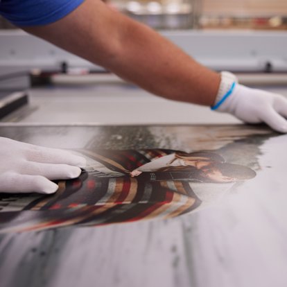 A worker inspects a print for quality