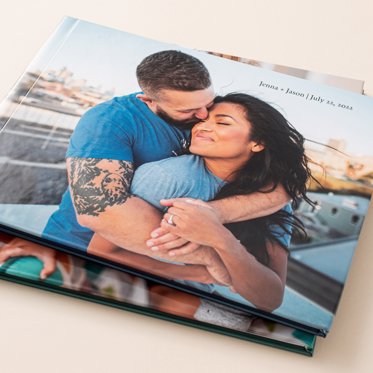 A Custom Hardcover Photo Book from Mpix with a smooth matte finish image cover of a couple hugging on a bridge. 