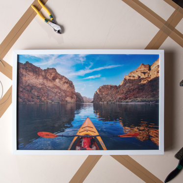 a framed print is inspected after being crafted in our lab 