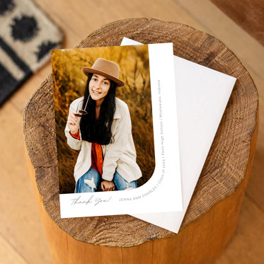 A graduation thank you card featuring a photo of a graduate and a space to write a custom thank you.