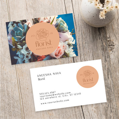 A colorful business card featuring flowers for a florist with their logo in the middle, the back offers more business details.