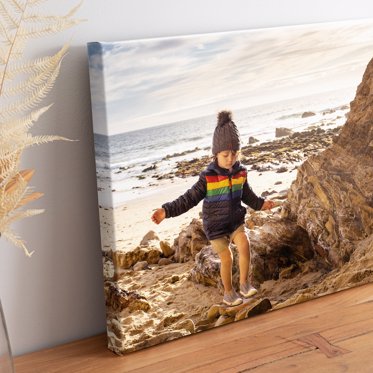 Canvas print of toddler exploring by the ocean