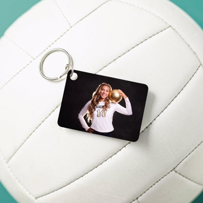 metal photo keychain with a photo of a volleyball player sitting on a volleyball