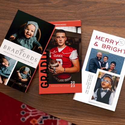 Three accordion photo book showing off a family portrait session, graduation photos, and holiday photos.