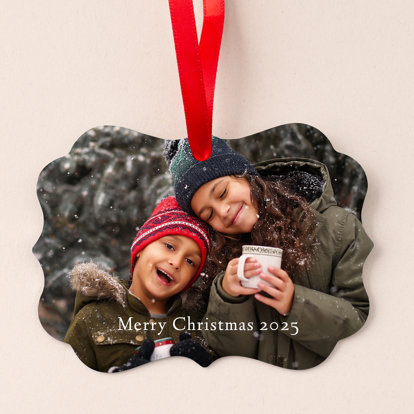 A custom-made photo ornament featuring a picture of a brother and sister in the snow with hot cocoa with text 'Merry Christmas 2025.'