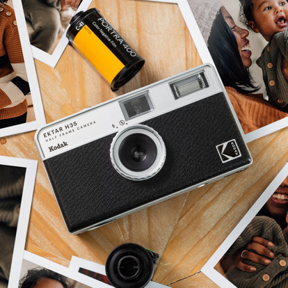 Kodak Ektar H35 half-frame camera on a wooden surface surrounded by printed family photographs and a roll of Kodak Portra 400 film.