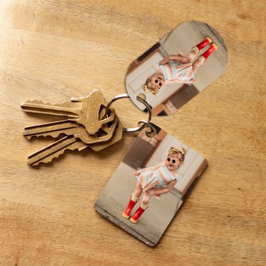 two different shape metal keychains are shown, one with rounded corners and one with a rectangular shape
