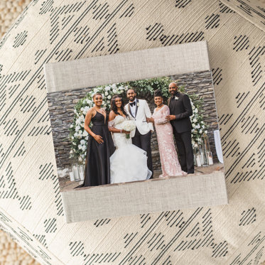 A Hardcover Wedding Photo Book from Mpix with a sand linen cover and skinny dust jacket featuring a family photo taken at a wedding. 