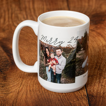 A white mug featuring a photo of a family outside with a holiday message of 'Merry 24"