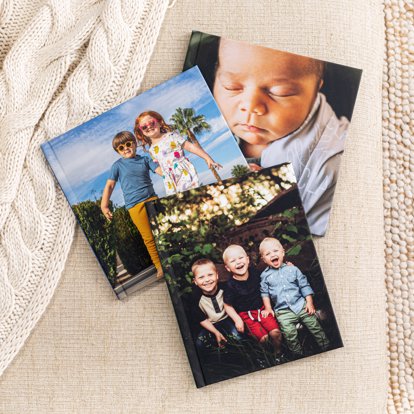 A collection of three custom cover classic photo books with matte image wrapped covers.