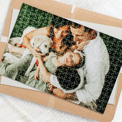 An assembled photo puzzle featuring an image of a family with their pet dog.