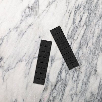 Two foam spacer strips sitting on a counter. 