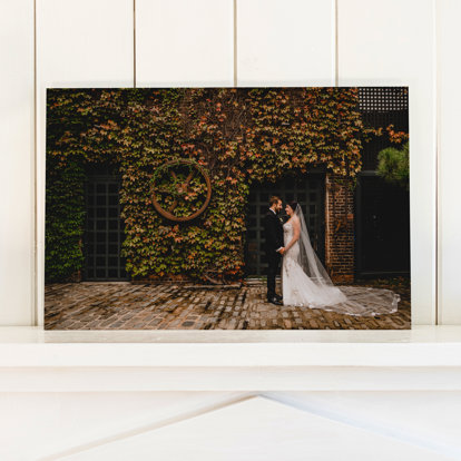 A wedding photo printed on acrylic mounted on a shelf.