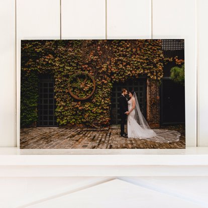 A wedding photo printed on acrylic mounted on a shelf.