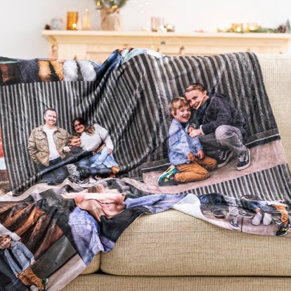 A large personalized blanket draped over a couch featuring images of a family in a collage design.