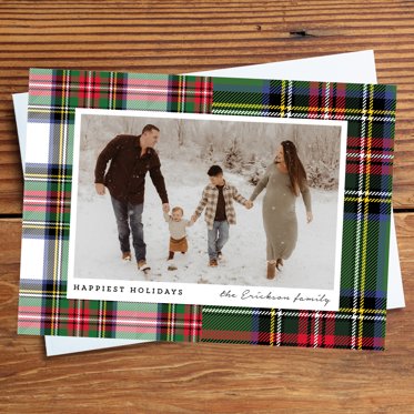 Holiday Photo Card from Mpix with "Happiest Holidays" and the family's name sitting on a white envelope with room for a personalized photo of your choice.