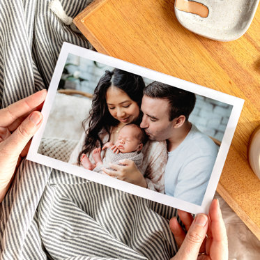 Mpix Softcover Photo Book with Large Image Cover of a couple holding their newborn. 