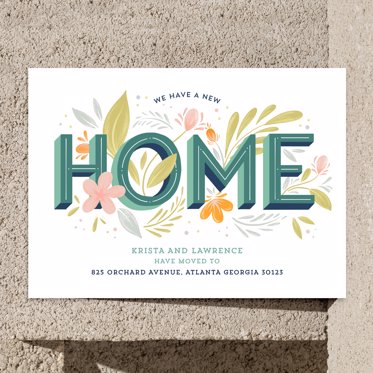 Moving announcement from Mpix with home written in geometric green text wrapped in flowers and your new home details below alerting friends and family of your move. 