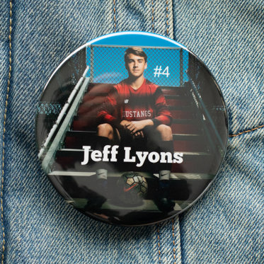 A photo button from Mpix featuring a sports photo of a high school athlete with their name written in white text to showcase the custom text feature.