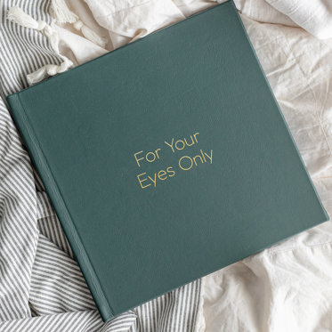 A Green Leather Boudoir Photo Album from Mpix with "For Your Eyes Only" written in Gold Debossing.