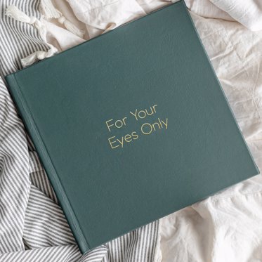 A Green Leather Boudoir Photo Album from Mpix with "For Your Eyes Only" written in Gold Debossing.