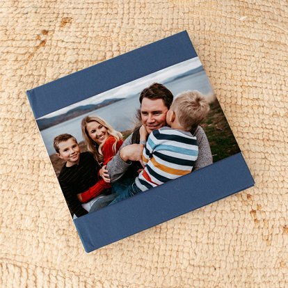 A blue linen cover premium photo book from Mpix with a skinny dust jacket featuring a personalized photo. 