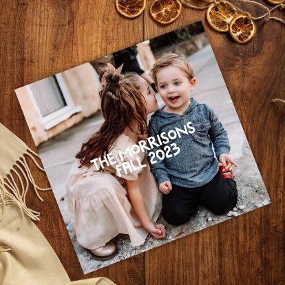 A family photo book with a picture on the cover of children and personalized text.