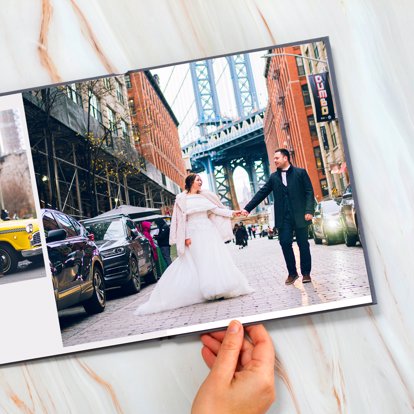 A gorgeous wedding photo album with a seamless two page spread featuring wedding day photos.