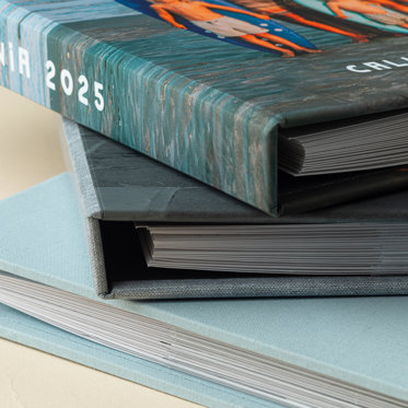 Three closed Slip-In Photo Albums from Mpix stacked on top of each other showing the wrap-around cover and how the pages lay when closed.