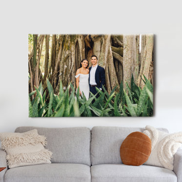 A canvas print from Mpix on a wall above a couch featuring a wedding image.