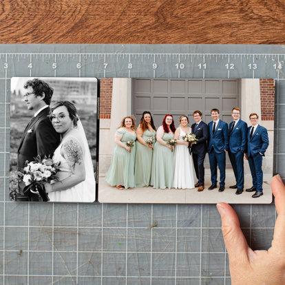 A close up of the hand of an Mpix worker doing a final inspection on a tabletop hinged print featuring two photos from a wedding.