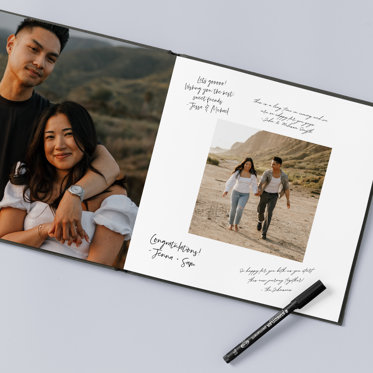 An open wedding guest book featuring engagement photos of the couple and messages & signatures from wedding guests.