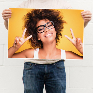 Hands holding a large poster print from Mpix showing the 1/8" border around all sides of the print.