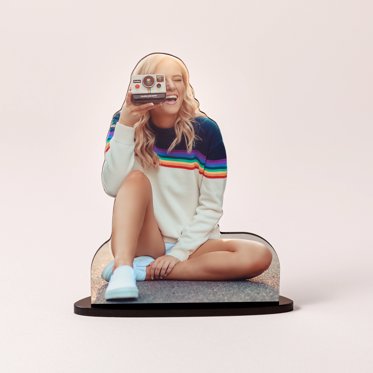 A personalized photo statuette cut out from Mpix featuring a girl taking a photo with an old film camera.